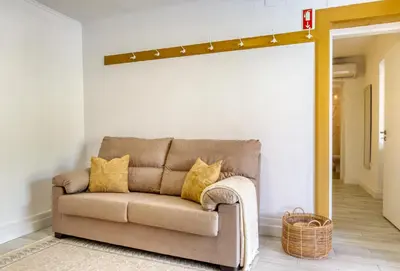 a living room with a couch and a wall with lights at Casa da Tia Celeste II, a Home in Madeira in Ponta do Sol