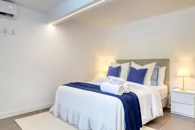 a bedroom with a large bed with towels on it at Casa da Tia Celeste III, a Home in Madeira in Ponta do Sol