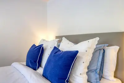a pile of blue pillows on a bed at Casa da Tia Celeste III, a Home in Madeira in Ponta do Sol