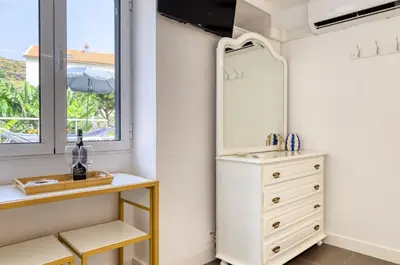 a bathroom with a sink and a mirror at Casa da Tia Celeste III, a Home in Madeira in Ponta do Sol