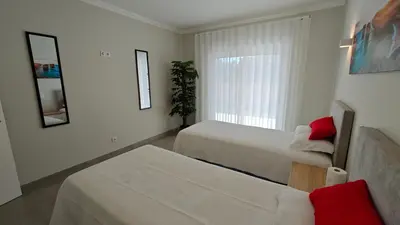a hotel room with two beds and a window at Boavista Golf and Spa Resort - Bayview Bellavista in Lagos