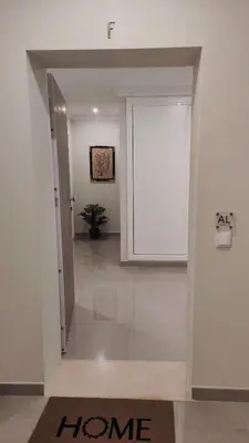 a hallway with a door with a home sign on it at Boavista Golf and Spa Resort - Bayview Bellavista in Lagos