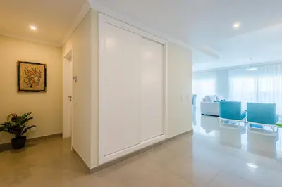 a large room with white walls and blue chairs at Boavista Golf and Spa Resort - Bayview Bellavista in Lagos