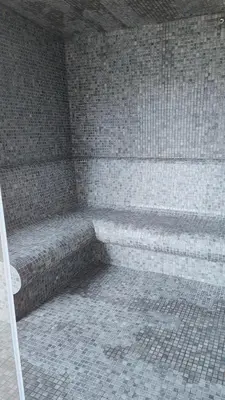 a brick wall with a bench in a room at Boavista Golf and Spa Resort - Bayview Bellavista in Lagos