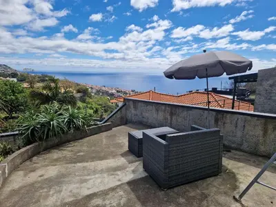 a living room with a couch and a desk at CoLiving Funchal in Funchal