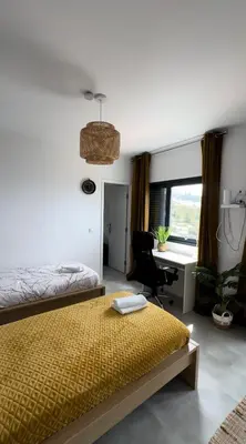 a bedroom with a bed and a painting on the wall at CoLiving Funchal in Funchal