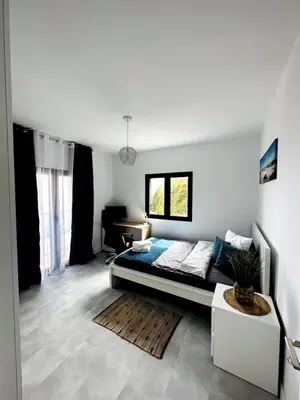 a small kitchen with a table and a sink at CoLiving Funchal in Funchal
