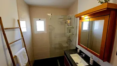 a bathroom with a sink and a shower and a mirror at Top Floor in Flor do Campo - Santana in Santana