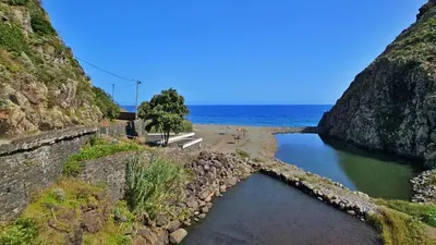 a body of water next to a beach and the ocean at Top Floor in Flor do Campo - Santana in Santana