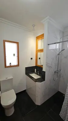 a bathroom with a toilet and a sink and a shower at Top Floor in Flor do Campo - Santana in Santana