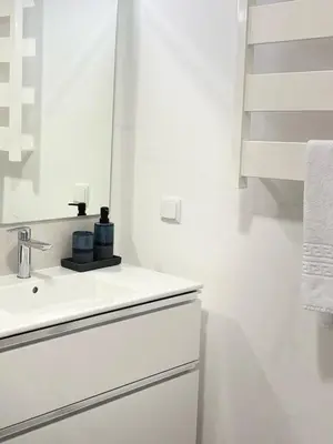 a white bathroom with a sink and a mirror at Casa Marguerite Gym and Hammam by Rentallido in Caniço