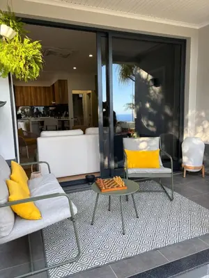 a living room with two chairs and a table at Casa Marguerite Gym and Hammam by Rentallido in Caniço