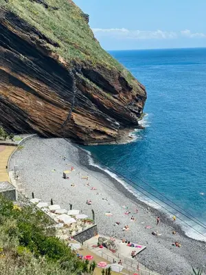 a beach with umbrellas and people on the beach at Casa Marguerite Gym and Hammam by Rentallido in Caniço