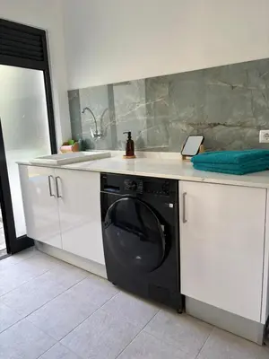 a kitchen with a washing machine and a sink at Casa Marguerite Gym and Hammam by Rentallido in Caniço