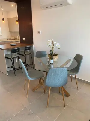 a dining room with a glass table and chairs at The Ocean View Luz in Luz