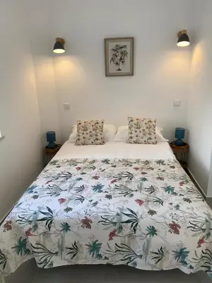 a bedroom with a bed with a floral bedspread at The Ocean View Luz in Luz