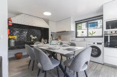 a kitchen and dining room with a table and chairs at Julianas House 1 by Atlantic Holiday in Campanário