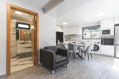 a kitchen and dining room with a table and chairs at Julianas House 1 by Atlantic Holiday in Campanário