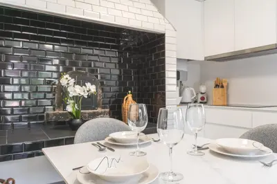 a table with chairs and wine glasses on it at Julianas House 1 by Atlantic Holiday in Campanário