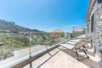 a balcony with chairs and a view of a mountain at Julianas House 1 by Atlantic Holiday in Campanário