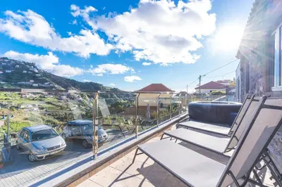 a balcony with chairs and a view of a car at Julianas House 1 by Atlantic Holiday in Campanário