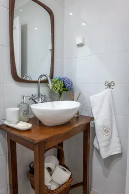a bathroom with a white sink and a mirror at Casa da Bisa, By OP in São Vicente