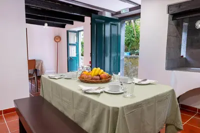 a table with a bowl of fruit on it at Casa da Bisa, By OP in São Vicente