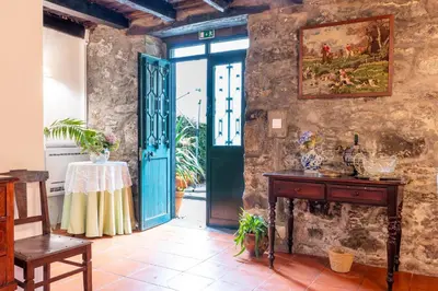a room with a green door and a table at Casa da Bisa, By OP in São Vicente