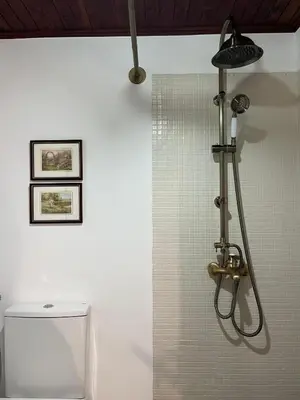a shower in a bathroom with a toilet at Casa da Bisa, By OP in São Vicente