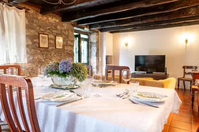 a dining room with a table with a white table cloth at Casa da Bisa, By OP in São Vicente