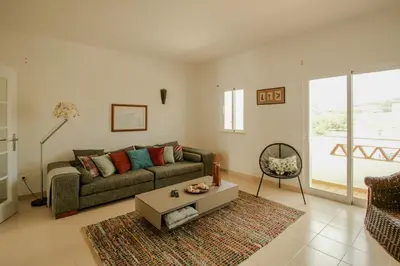 a living room with a couch and a table at FLH Budens Duplex with Terrace in Vila do Bispo