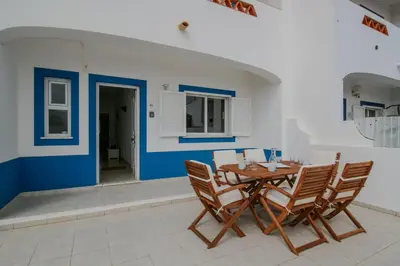 a dining room with a wooden table and chairs at FLH Budens Duplex with Terrace in Vila do Bispo