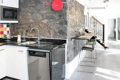 a kitchen with a sink and a counter top at Casa das Orquideas in Estreito da Calheta