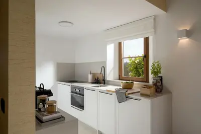 a white kitchen with a sink and a window at 2 bdr Villa with Ocean-View Shared Pool, Luz, Lagos in Luz
