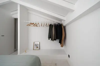 a bedroom with a bed and a white wall at 2 bdr Villa with Ocean-View Shared Pool, Luz, Lagos in Luz