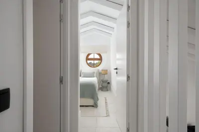 a white bedroom with a bed and a window at 2 bdr Villa with Ocean-View Shared Pool, Luz, Lagos in Luz