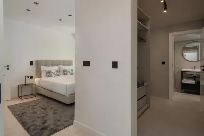 a bedroom with a white bed and a sink at Garden Villa by An Island Apart in Funchal