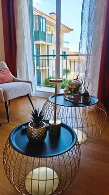 a living room with two tables with plants on them at Stay In Funchal- Alto da Pena Apartment in Funchal
