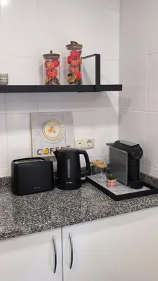 a kitchen counter with two toasters and a microwave at Stay In Funchal- Alto da Pena Apartment in Funchal
