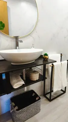 a bathroom with a sink and a mirror on a table at Stay In Funchal- Alto da Pena Apartment in Funchal