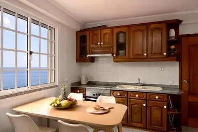 a kitchen with a table with a bowl of fruit on it at Taste of the Sea by Formosa in Funchal