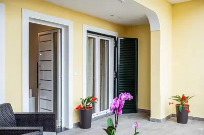a porch with two plants and a window at Hidden Corner by Sabugo House in Ponta do Sol