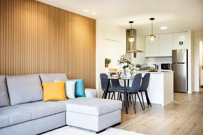 a living room and kitchen with a couch and a table at Hidden Corner by Sabugo House in Ponta do Sol