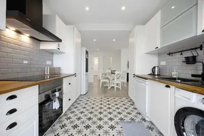 a kitchen with white cabinets and a stove at Villa Vista Azul - Praia Da Luz in Luz