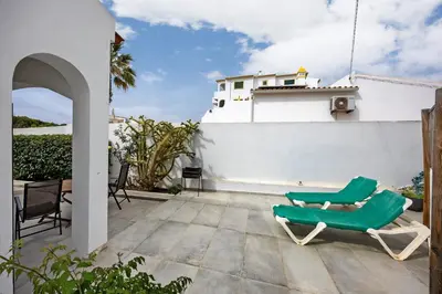 a bedroom with a bed and a table and a rug at Villa Vista Azul - Praia Da Luz in Luz