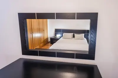 a bedroom with a bed and a large mirror at Madalenas Sun&Sea in Funchal