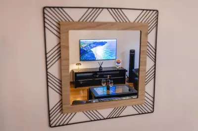 a mirror reflecting a living room with a tv at Madalenas Sun&Sea in Funchal