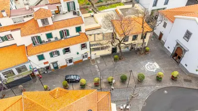 an overhead view of a city with orange roofs at Lobos Village in Câmara de Lobos