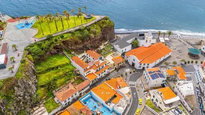an aerial view of a resort near the ocean at Lobos Village in Câmara de Lobos