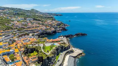 an aerial view of a city and the ocean at Lobos Village in Câmara de Lobos